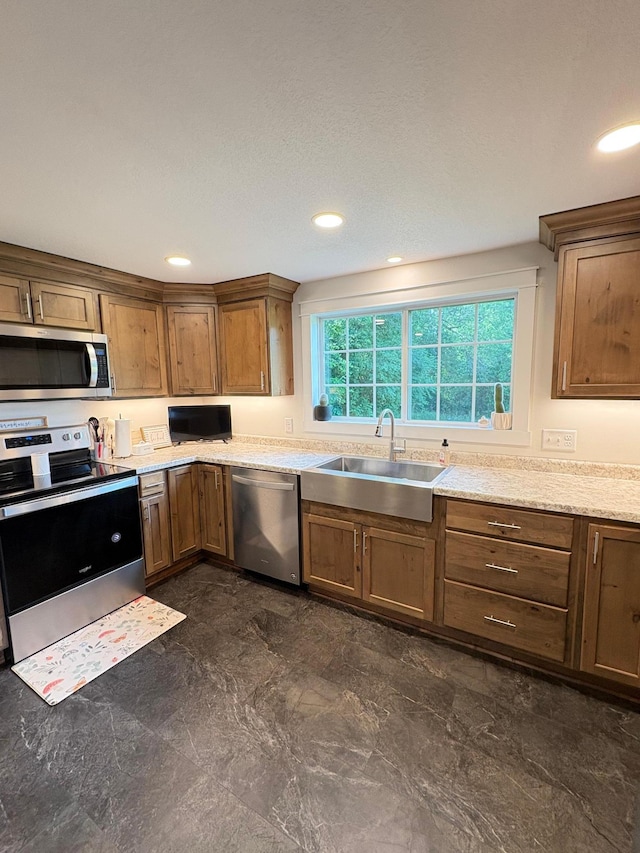 2812 150th St, Maxwell Twp, MN 56232 - kitchen featuring appliances with stainless steel finishes, brown cabinets, and recessed lighting