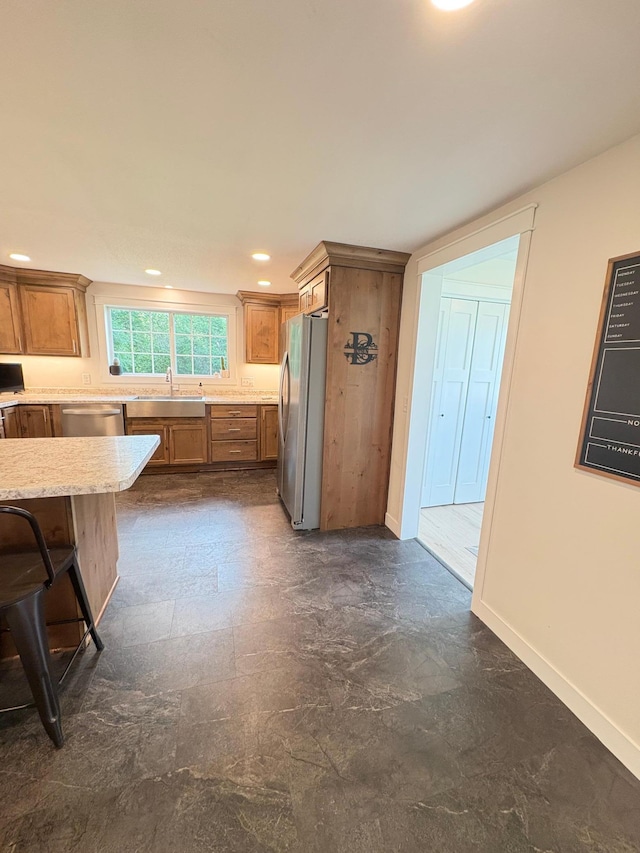 2812 150th St, Maxwell Twp, MN 56232 - kitchen featuring appliances with stainless steel finishes, brown cabinets, recessed lighting, and light stone counters