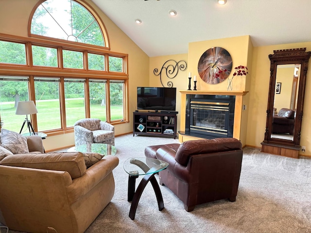 14158 185th Ave NE, Smiley Twp, MN 56701 - carpeted living room with a glass covered fireplace, healthy amount of natural light, recessed lighting, and high vaulted ceiling