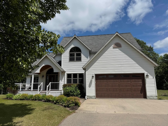 14158 185th Ave NE, Smiley Twp, MN 56701 - traditional-style house featuring a porch, a front lawn, concrete driveway, and an attached garage