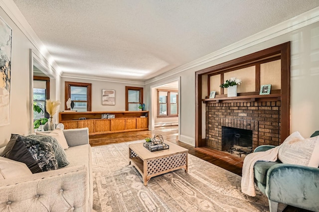 983 18th Ave SE, Minneapolis, MN 55414 - living area featuring a textured ceiling, crown molding, a baseboard heating unit, a brick fireplace, and wood finished floors