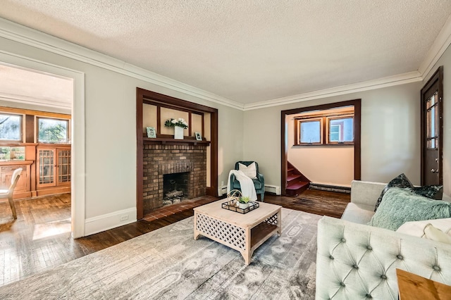 983 18th Ave SE, Minneapolis, MN 55414 - living area featuring hardwood / wood-style floors, crown molding, a textured ceiling, a brick fireplace, and a baseboard heating unit