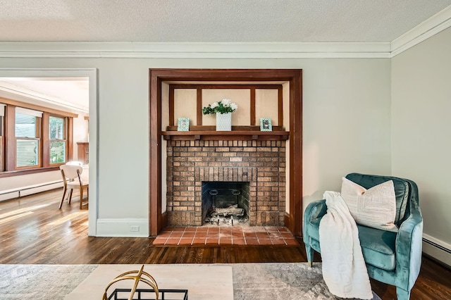 983 18th Ave SE, Minneapolis, MN 55414 - living area featuring wood finished floors, crown molding, a textured ceiling, a fireplace, and a baseboard radiator