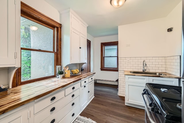 983 18th Ave SE, Minneapolis, MN 55414 - kitchen featuring wooden counters, stainless steel range with electric stovetop, white cabinetry, tasteful backsplash, and a baseboard heating unit