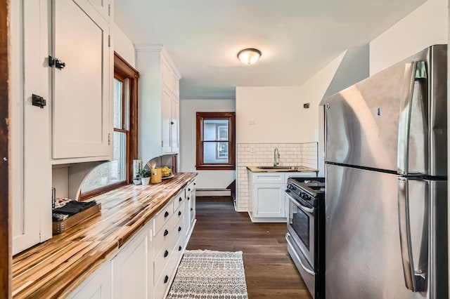 983 18th Ave SE, Minneapolis, MN 55414 - kitchen featuring appliances with stainless steel finishes, butcher block counters, white cabinets, and dark wood-style flooring