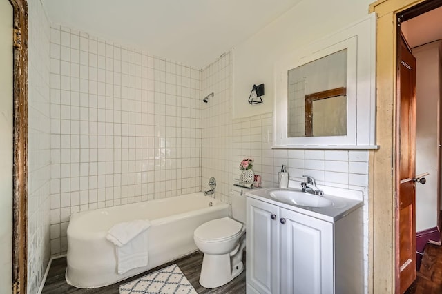983 18th Ave SE, Minneapolis, MN 55414 - bathroom with tile walls, wood finished floors, vanity, and shower / bathtub combination