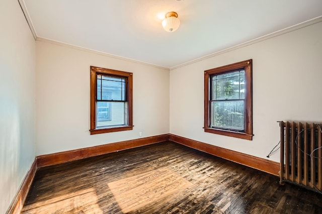 983 18th Ave SE, Minneapolis, MN 55414 - unfurnished room with crown molding, dark wood-style floors, and radiator
