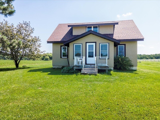 N7420 110th St, Spring Lake Twp, WI 54767 - bungalow-style house with a shingled roof, a front yard, stucco siding, and covered porch