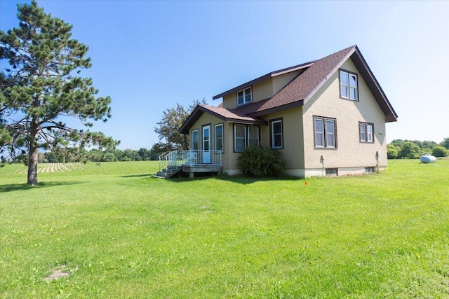 N7420 110th St, Spring Lake Twp, WI 54767 - view of side of home with a yard, stucco siding, and a shingled roof