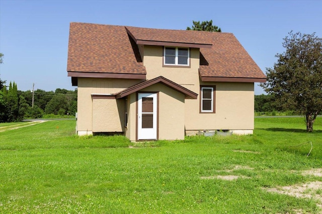 N7420 110th St, Spring Lake Twp, WI 54767 - rear view of property featuring stucco siding, a shingled roof, and a yard