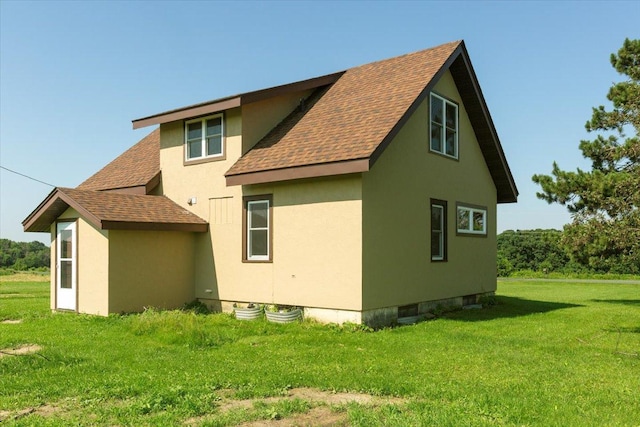 N7420 110th St, Spring Lake Twp, WI 54767 - view of home's exterior with roof with shingles, a yard, and stucco siding