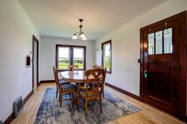 N7420 110th St, Spring Lake Twp, WI 54767 - dining room with light wood-style floors and a chandelier