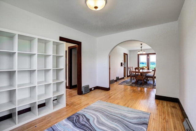 N7420 110th St, Spring Lake Twp, WI 54767 - sitting room featuring arched walkways, wood-type flooring, and a baseboard heating unit