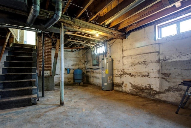 N7420 110th St, Spring Lake Twp, WI 54767 - below grade area featuring water heater, a water pressure tank, and stairs