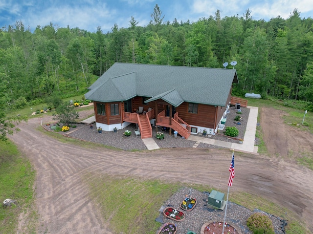 N5020 Red Pine Trl, Evergreen Twp, WI 54801 - view of front of home with a wooded view, covered porch, dirt driveway, and stairway