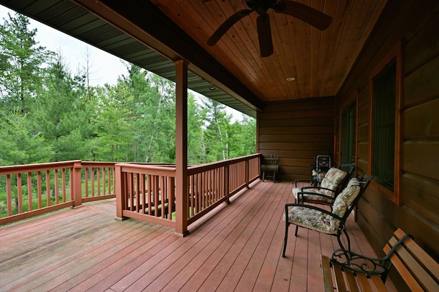 N5020 Red Pine Trl, Evergreen Twp, WI 54801 - wooden terrace featuring a ceiling fan and a wooded view