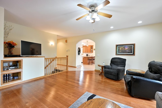 N5020 Red Pine Trl, Evergreen Twp, WI 54801 - living area with arched walkways, wood finished floors, ceiling fan, and recessed lighting
