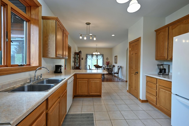 N5020 Red Pine Trl, Evergreen Twp, WI 54801 - kitchen with white appliances, a chandelier, decorative light fixtures, a peninsula, and light countertops