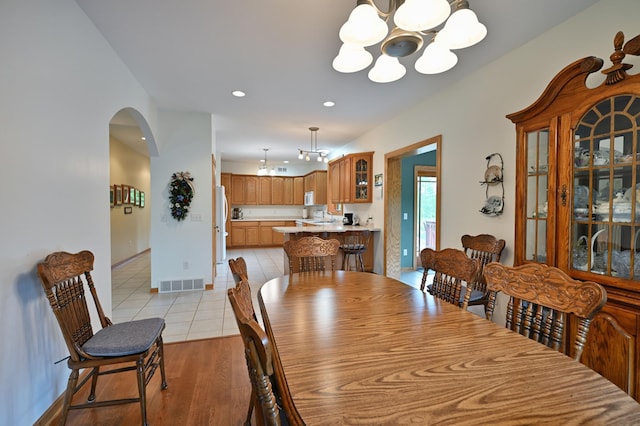 N5020 Red Pine Trl, Evergreen Twp, WI 54801 - dining space featuring a chandelier, arched walkways, light tile patterned flooring, and recessed lighting