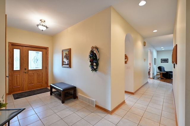 N5020 Red Pine Trl, Evergreen Twp, WI 54801 - foyer entrance featuring light tile patterned flooring, arched walkways, and recessed lighting
