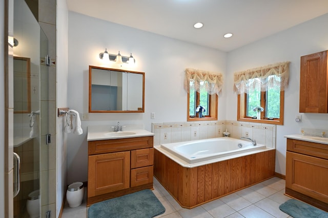 N5020 Red Pine Trl, Evergreen Twp, WI 54801 - bathroom with two vanities, a shower stall, a bath, tile patterned floors, and recessed lighting