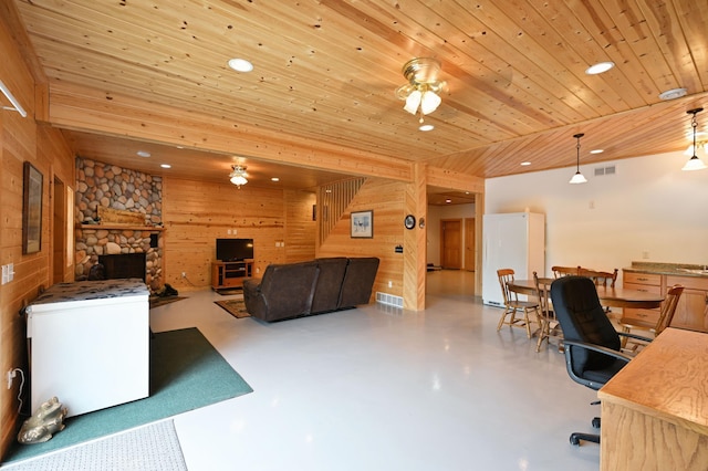 N5020 Red Pine Trl, Evergreen Twp, WI 54801 - living room with a ceiling fan, recessed lighting, wood ceiling, finished concrete floors, and wood walls