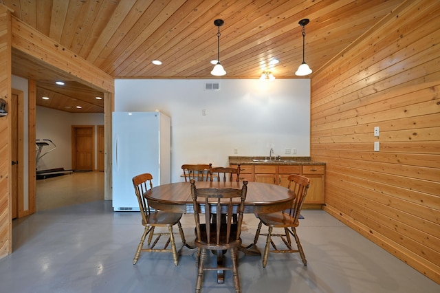 N5020 Red Pine Trl, Evergreen Twp, WI 54801 - dining room with bar with sink, concrete floors, wooden ceiling, wooden walls, and recessed lighting