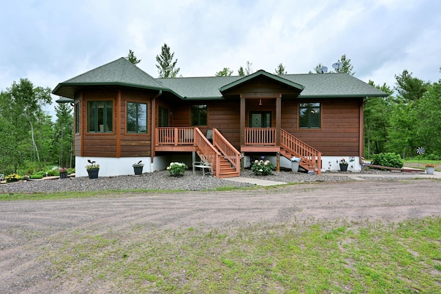N5020 Red Pine Trl, Evergreen Twp, WI 54801 - rustic home with a porch, roof with shingles, and stairs