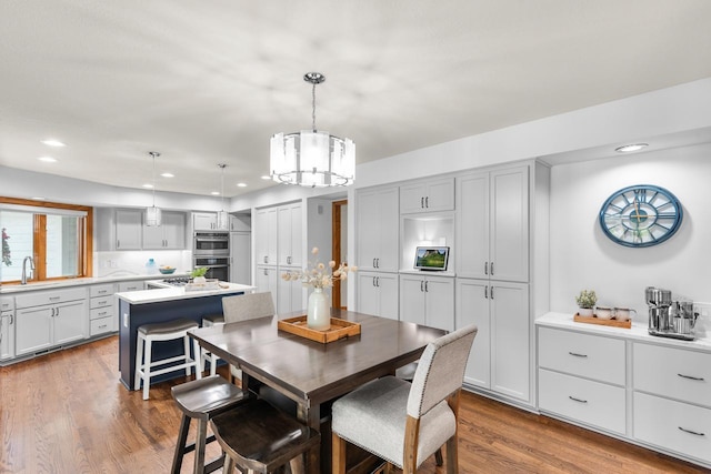11280 Bluestem Ln, Eden Prairie, MN 55347 - dining room featuring a chandelier, dark wood-style floors, and recessed lighting