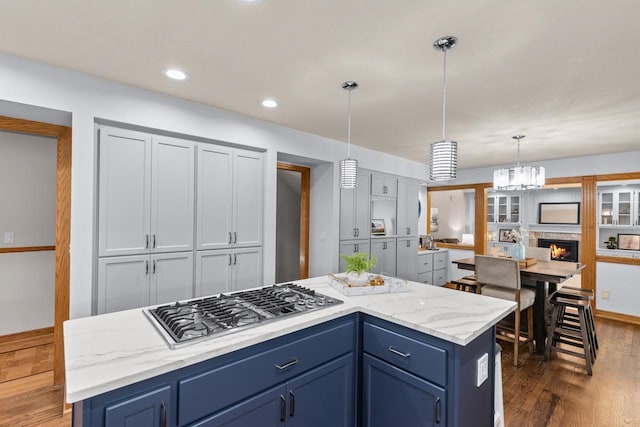 11280 Bluestem Ln, Eden Prairie, MN 55347 - kitchen featuring stainless steel gas stovetop, blue cabinets, dark wood-type flooring, hanging light fixtures, and recessed lighting