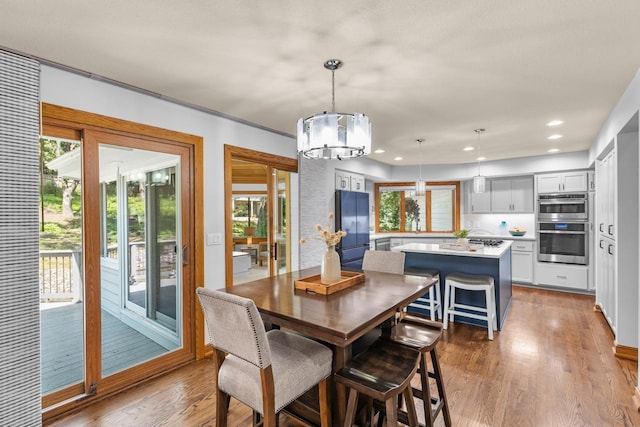 11280 Bluestem Ln, Eden Prairie, MN 55347 - dining area with a chandelier, plenty of natural light, wood finished floors, and recessed lighting
