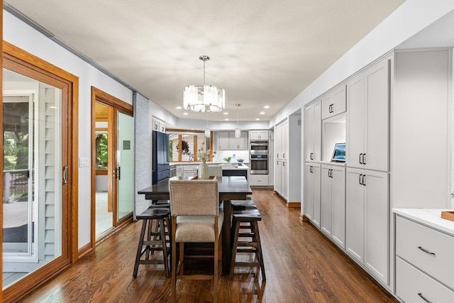 11280 Bluestem Ln, Eden Prairie, MN 55347 - dining space with a chandelier, dark wood-style flooring, and recessed lighting
