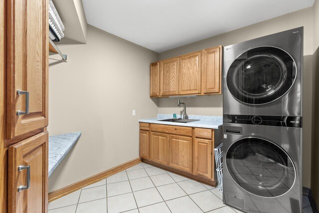 11280 Bluestem Ln, Eden Prairie, MN 55347 - laundry room with estacked washer and dryer, cabinet space, and light tile patterned floors