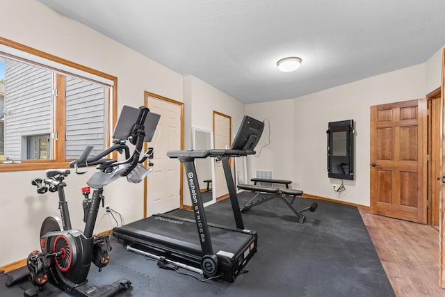 11280 Bluestem Ln, Eden Prairie, MN 55347 - exercise room featuring baseboards and light wood-style flooring