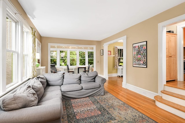 901 42nd St, Minneapolis, MN 55409 - living room with light wood-type flooring, stairway, and ornate columns