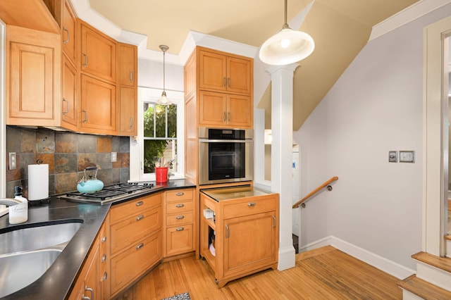 901 42nd St, Minneapolis, MN 55409 - kitchen with stainless steel appliances, light wood finished floors, dark countertops, decorative backsplash, and pendant lighting