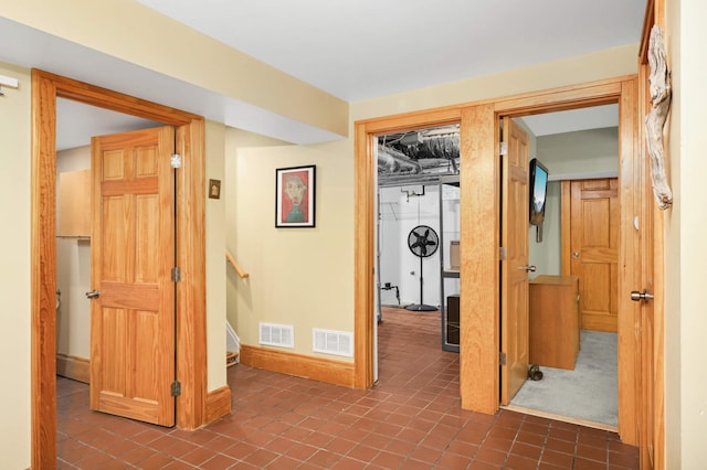 901 42nd St, Minneapolis, MN 55409 - corridor featuring dark tile patterned flooring and baseboards