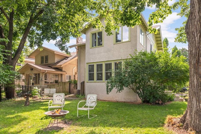 901 42nd St, Minneapolis, MN 55409 - rear view of property featuring stucco siding and a fire pit