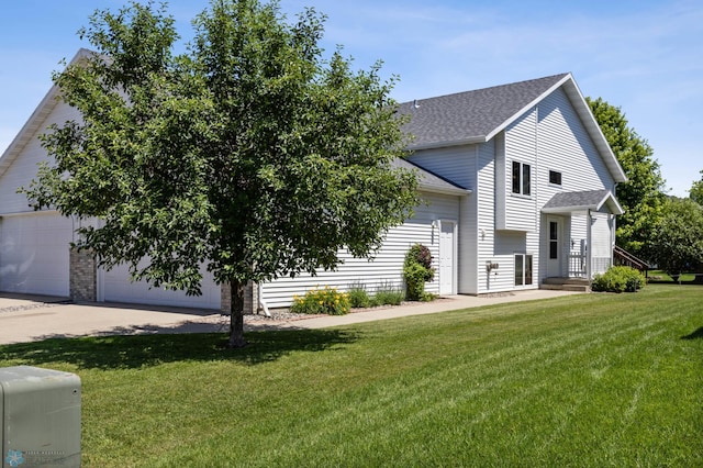 2812 Wheatland Dr S, Fargo, ND 58103 - view of front facade featuring roof with shingles, a front lawn, a garage, and driveway