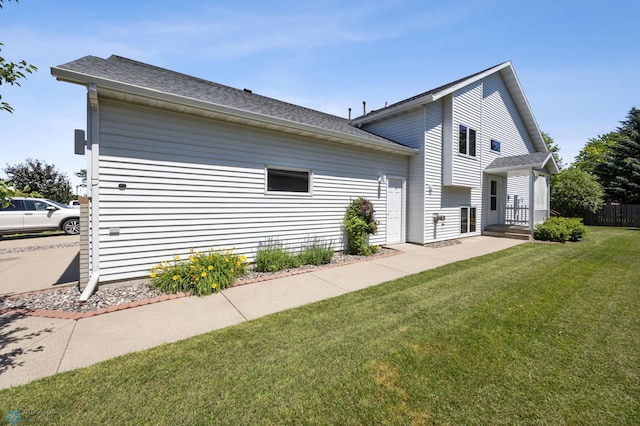 2812 Wheatland Dr S, Fargo, ND 58103 - view of property exterior with roof with shingles and a lawn