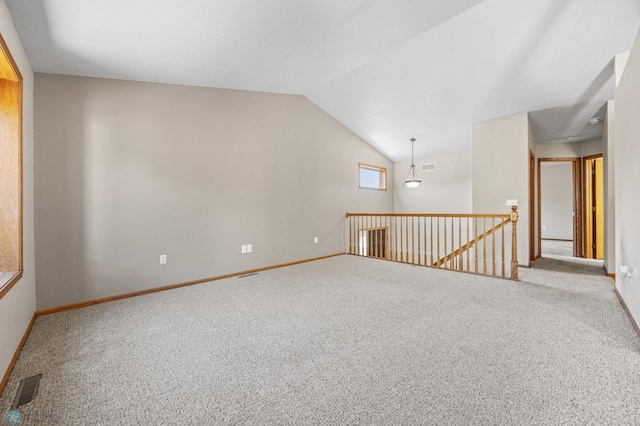 2812 Wheatland Dr S, Fargo, ND 58103 - empty room featuring carpet flooring and vaulted ceiling