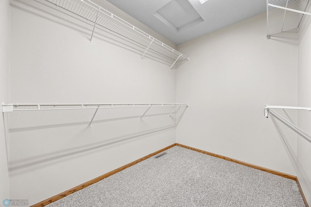 2812 Wheatland Dr S, Fargo, ND 58103 - walk in closet with carpet flooring and attic access