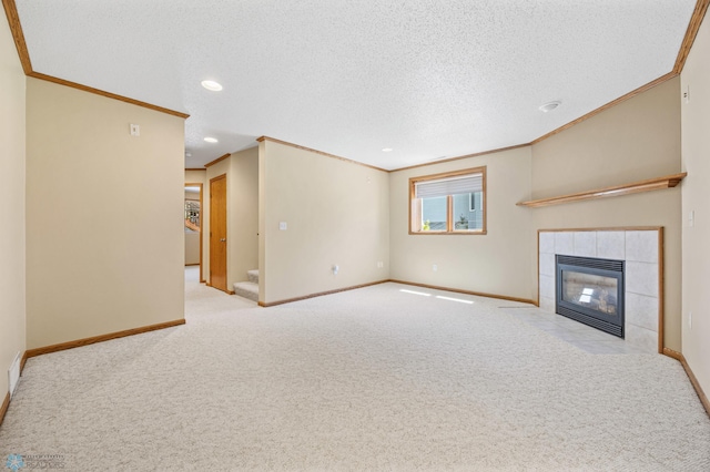 2812 Wheatland Dr S, Fargo, ND 58103 - unfurnished living room featuring crown molding, carpet, a textured ceiling, a tiled fireplace, and recessed lighting