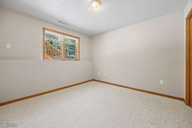 2812 Wheatland Dr S, Fargo, ND 58103 - carpeted empty room featuring a textured ceiling and baseboards
