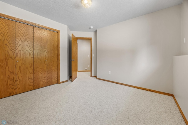 2812 Wheatland Dr S, Fargo, ND 58103 - unfurnished bedroom with carpet flooring, a closet, and a textured ceiling