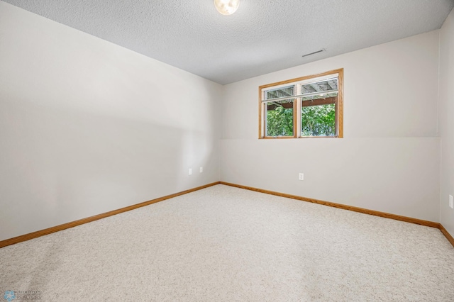 2812 Wheatland Dr S, Fargo, ND 58103 - carpeted empty room featuring a textured ceiling and baseboards