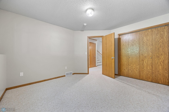 2812 Wheatland Dr S, Fargo, ND 58103 - unfurnished bedroom featuring carpet floors, a textured ceiling, and a closet