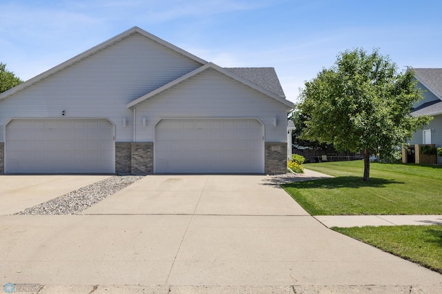 2812 Wheatland Dr S, Fargo, ND 58103 - view of front of property with a front lawn, concrete driveway, an attached garage, and brick siding