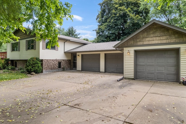 39123 Kc Dr, Homer Twp, MN 55987 - tri-level home with an attached garage, concrete driveway, and brick siding
