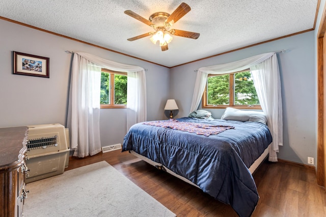 39123 Kc Dr, Homer Twp, MN 55987 - bedroom with multiple windows, ornamental molding, wood finished floors, a textured ceiling, and ceiling fan